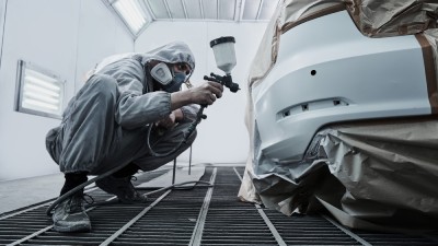 a person painting car parts